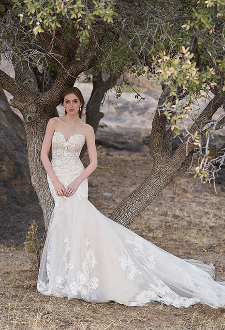 woman standing under tree wearing allure bridal dress style 9756
