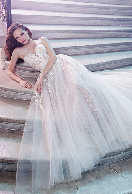enzoani-pixie-dress-detail bride wearing enzoani pixie wedding dress and sitting on staircase