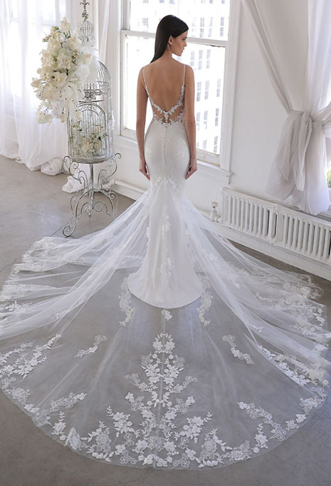 bride modeling back of blue by enzoani wedding gown