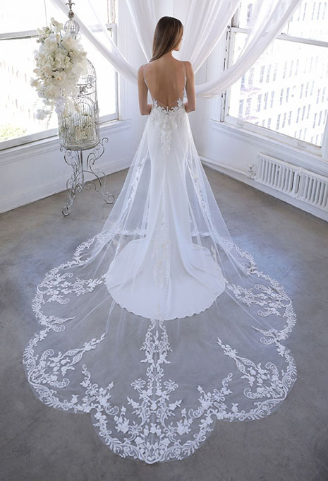 bride modeling back of ozalea dress with lace train