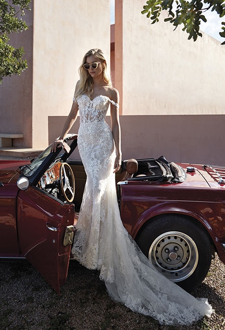 front view of ​Pronovias Phuket wedding dress standing in front of car