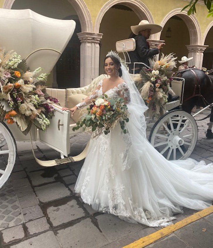 Monica smiling in her wedding dress on her big day