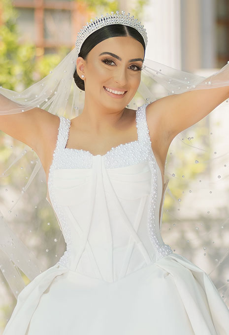 bride wearing custom made wedding gown and veil from karoza bridal