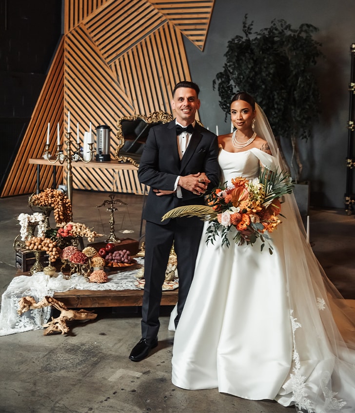 Gabriela Shaker and her husband smiling for portrait on their big day