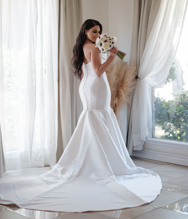 side view of mary smiling in her wedding gown