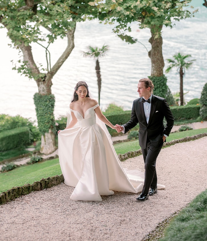 husband and wife laughing while holding hands