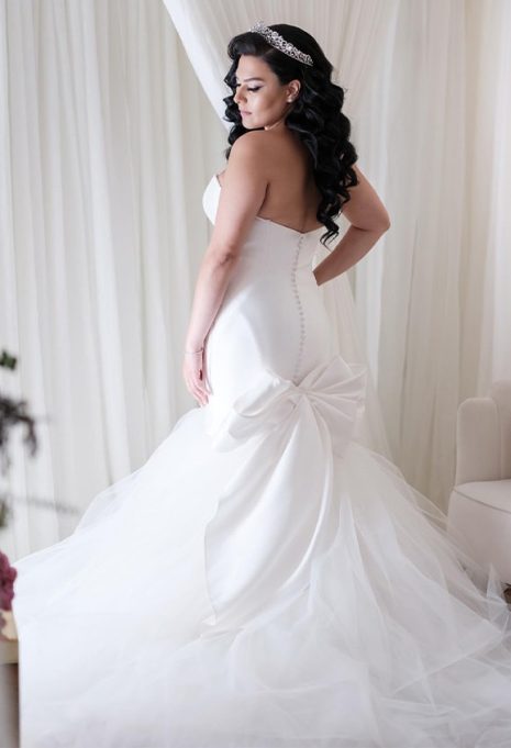 side view of bride posing in her wedding gown