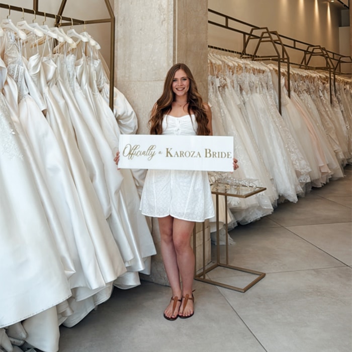 bride holding i said yes signage