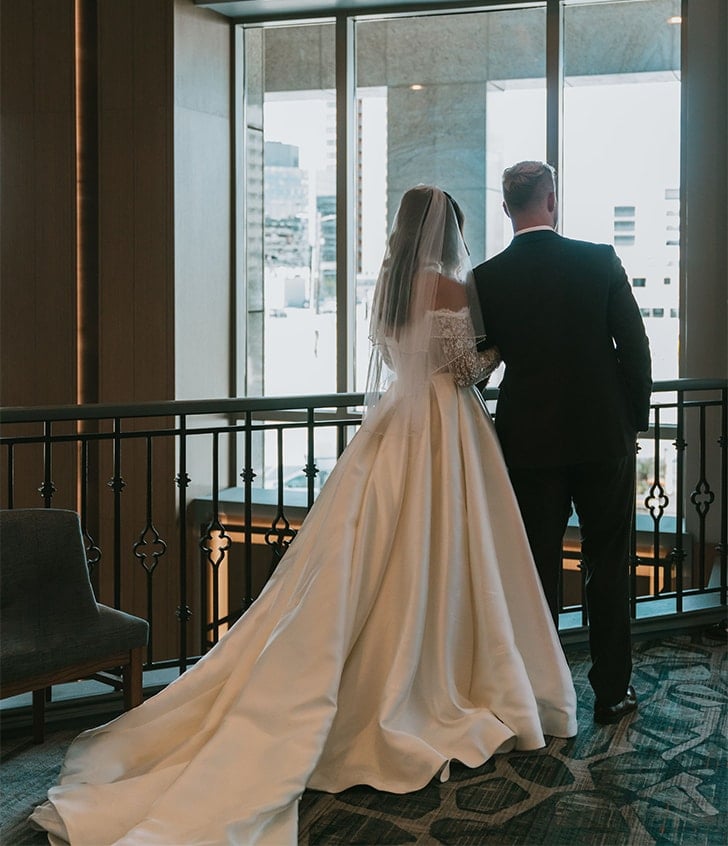 back view of gabby the bride and her husband