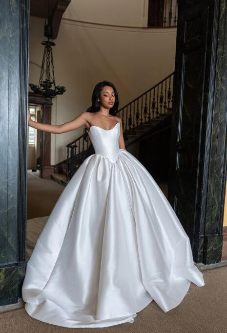 Model wearing Blanche Bridal Manon posing in doorway