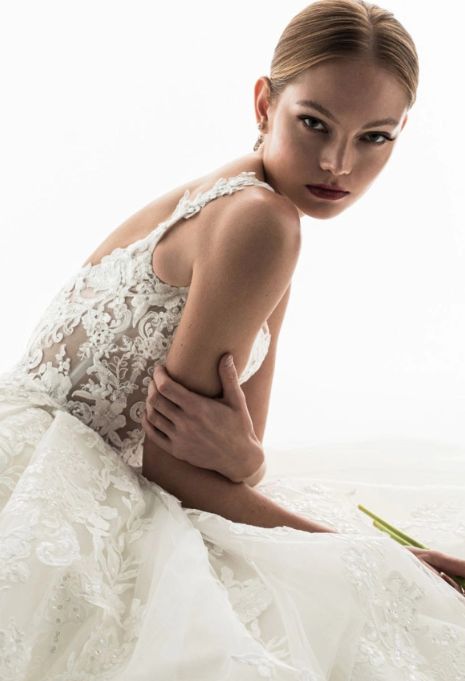 Model wearing the ÉLYSÉE Privé Geranium gown up close from the side